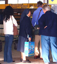 Nun boarding Galapagos flight carrying a TV aerial